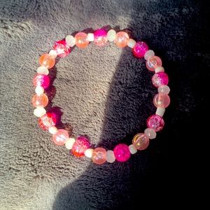 dark pink bracelet with light pink accents and white beads
